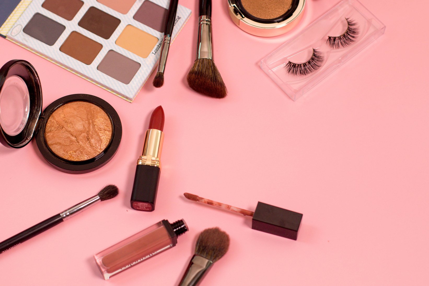 Beauty Products on Pink Surface Flatlay